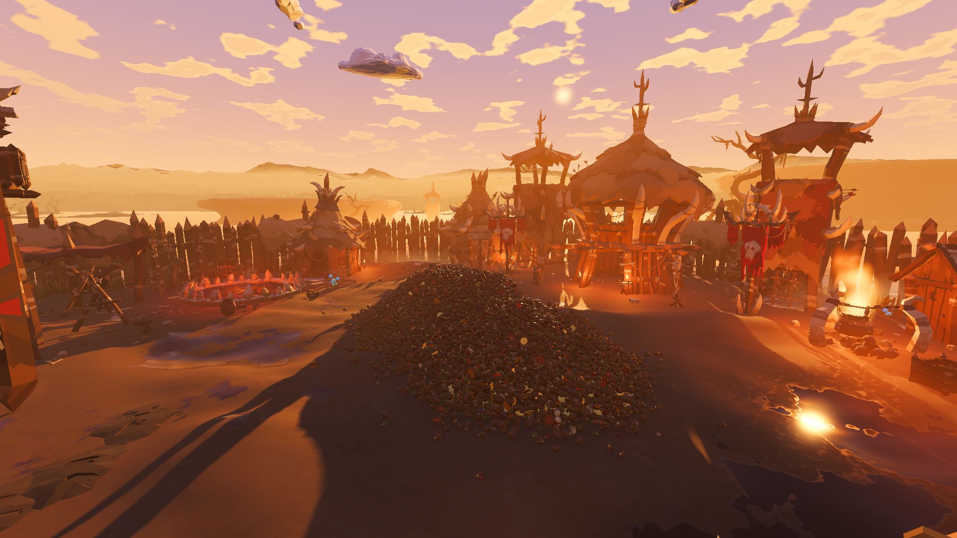 The goblin war camp at golden hour from above its yard: the heap of droppings in the middle, the palisade, horned watchtowers, a bonfire and a ring of spikes around it, and a hazy bog stretching away behind.