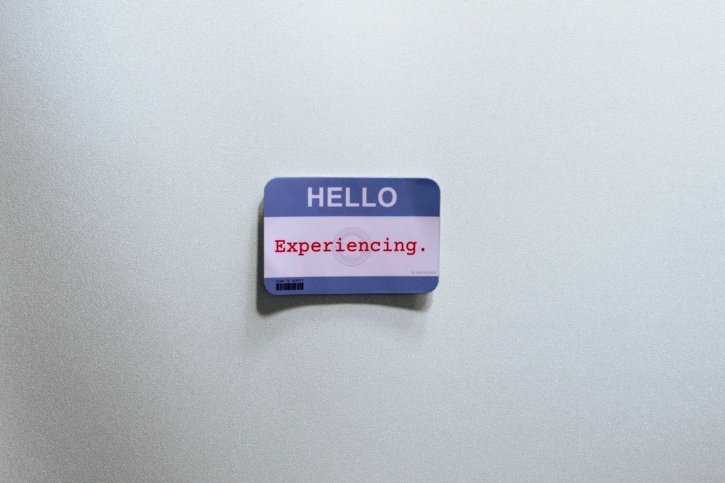 Nametag Sticker — “HELLO — Experiencing” — 3×2 in Waterproof Vinyl